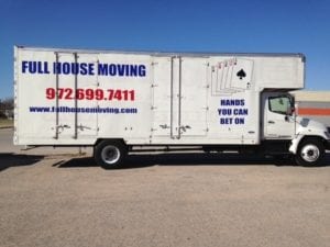 White moving truck with red and blue vinyl decals for moving company