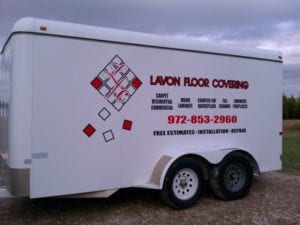 White covered trailer with vinyl decals for a floor covering company